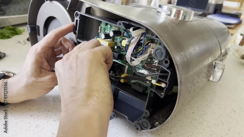 MELBOURNE, AUSTRALIA - September 6, 2025: electronics repair, assembling circuit boards in a modern stand mixer.