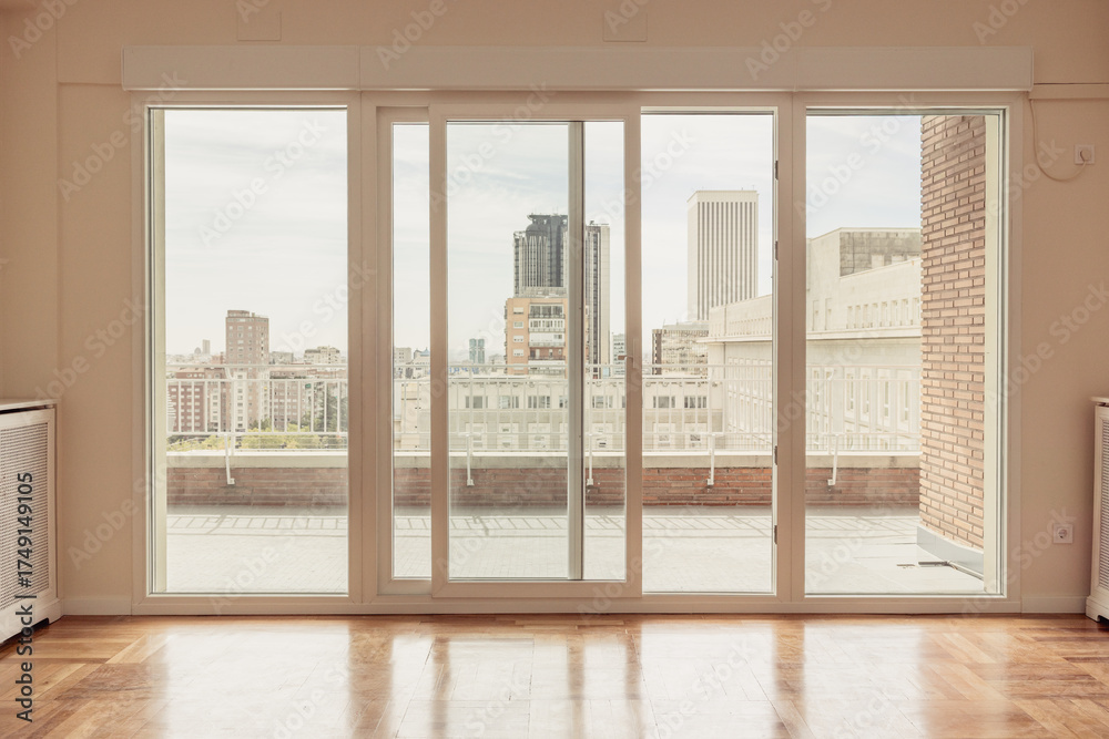 Fototapeta premium Empty apartment with terrace with views of Madrid skyline