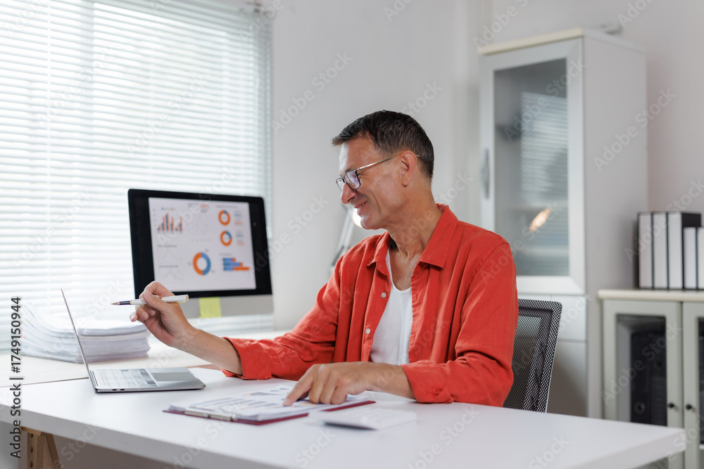 Fototapeta premium Mature man analyzing business data in office