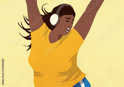 Carefree young woman with headphones listening to music and dancing with arms raised
