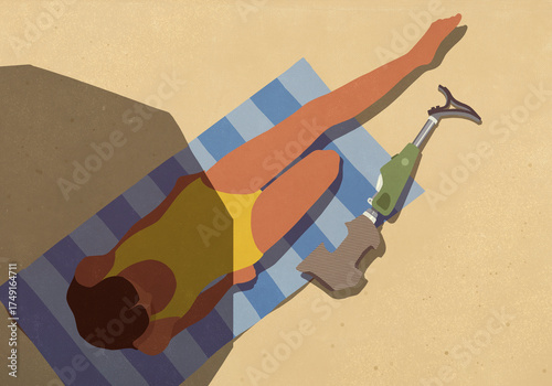 View from above woman removing prosthetic leg, sunbathing on summer beach
