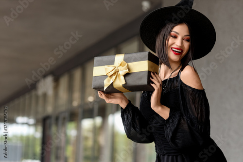 Happy young woman in witch ...