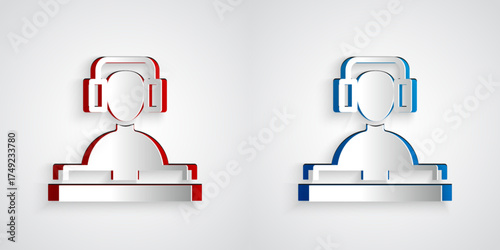 Paper cut DJ wearing headphones in front of record decks icon isolated on grey background. DJ playing music. Paper art style. Vector