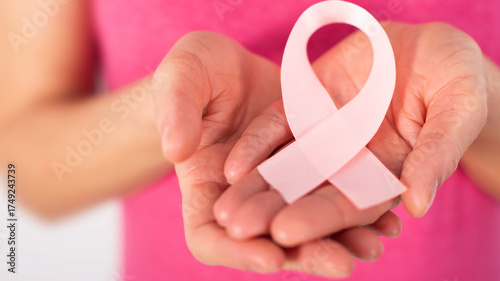 Wallpaper Mural Caucasian female middle aged model shows breast cancer awareness pink ribbon closeup view Torontodigital.ca