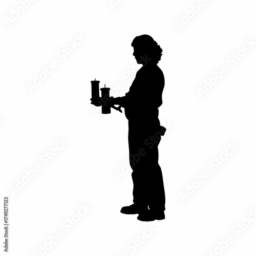 Silhouette of a worker lighting candles for a calm rehab environment isolated on white background