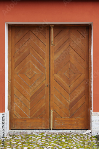 Wallpaper Mural Closed double wooden door sits within a vivid red wall. Classic architecture Torontodigital.ca