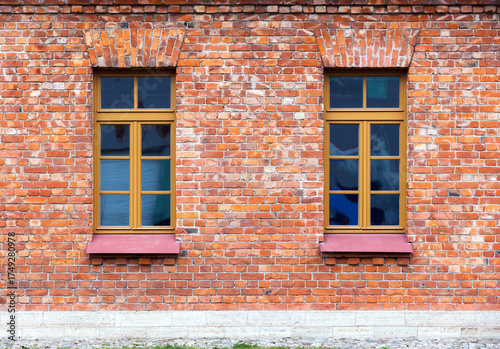 Wallpaper Mural Two windows with wooden frames set in a rustic red brick wall. Photo texture Torontodigital.ca