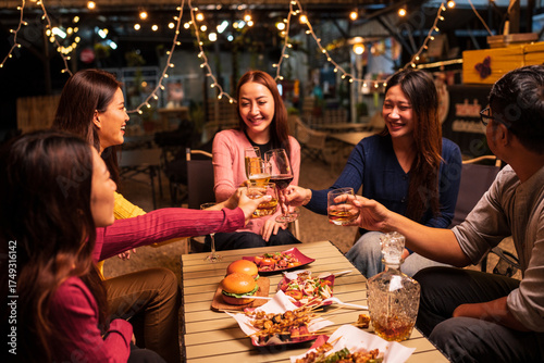 Group of Asians are having a celebration at a restaurant with drinks.	