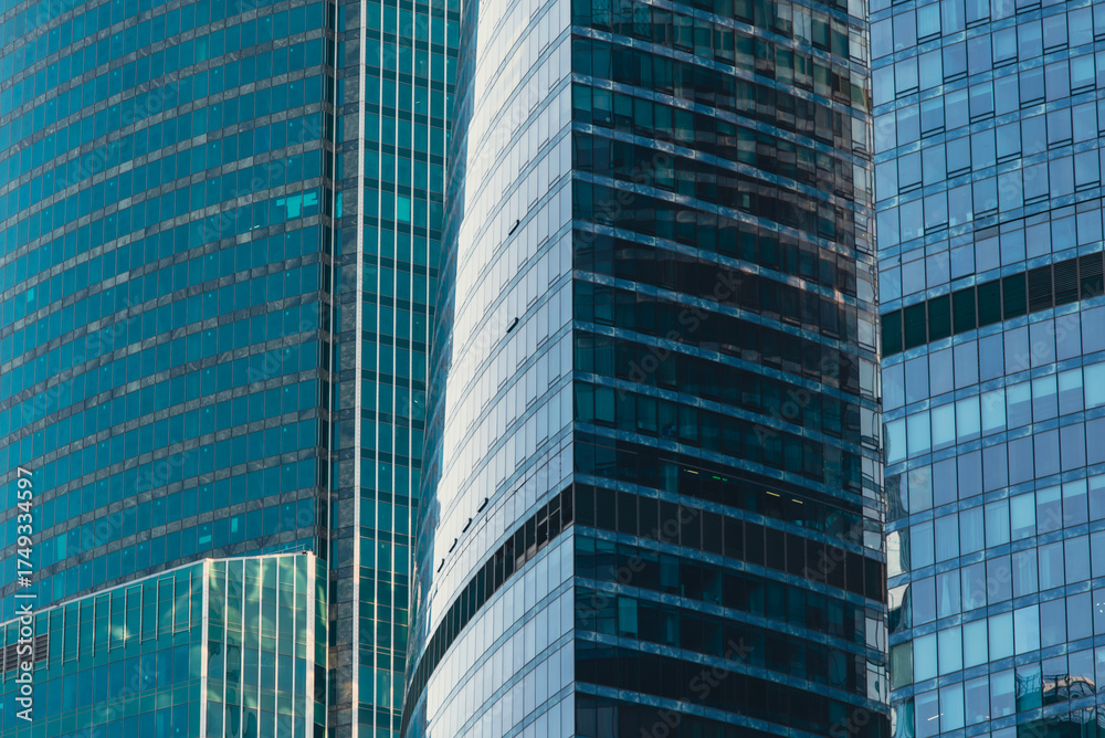 Fototapeta premium mirrored windows of the facade of an office building
