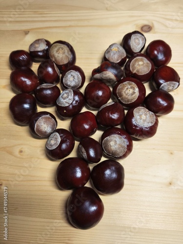 Chestnuts Arranged in Heart Shape on Wooden Table