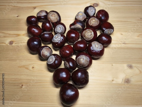 Chestnuts Arranged in Heart Shape on Wooden Table