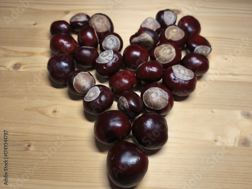 Chestnuts Arranged in Heart Shape on Wooden Table