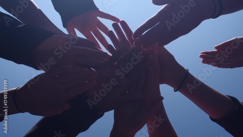 Team huddle hands touch together teamwork spirit blue sky