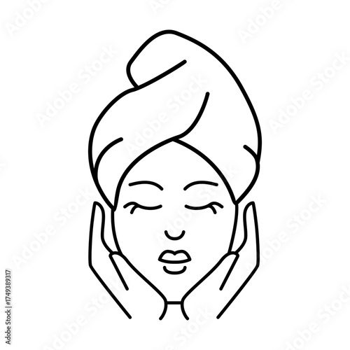 A serene woman with her eyes closed and a contented smile wrapped in a towel on her head looking refreshed