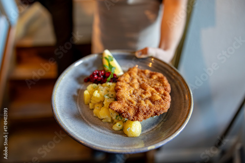 Stockholm, Sweden A plate of fried and breaded veal schnitzel with potato salad.