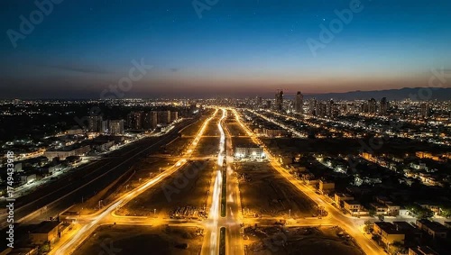 Wallpaper Mural Aerial view of a city at dusk. Buildings and roads stretch towards the horizon.  City lights glow Torontodigital.ca