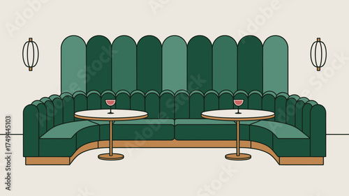 A green booth with two tables and two wine glasses and two wall lamps in a restaurant setting is shown