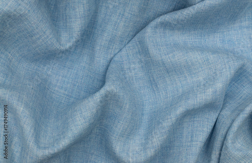 Blue linen texture. Light blue fabric surface with soft folds. Linen knitted fabric. Linen fabric. Light blue linen background. Blue fabric texture background. Textile material for design.