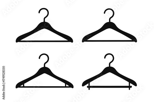 Set of four black clothes hangers on white background
