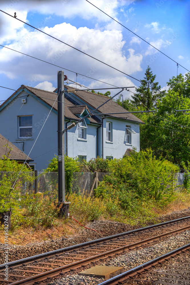 Fototapeta premium cottage next to railway line