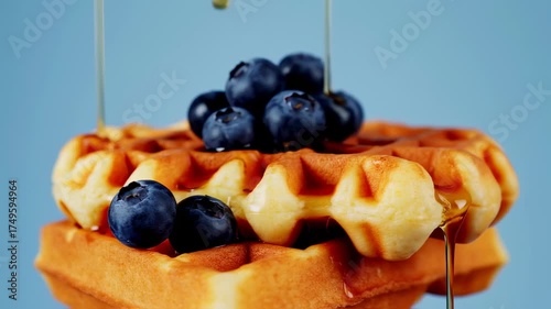 Delicious Waffles with Blueberries and Syrup, a Tasty Breakfast Treat.