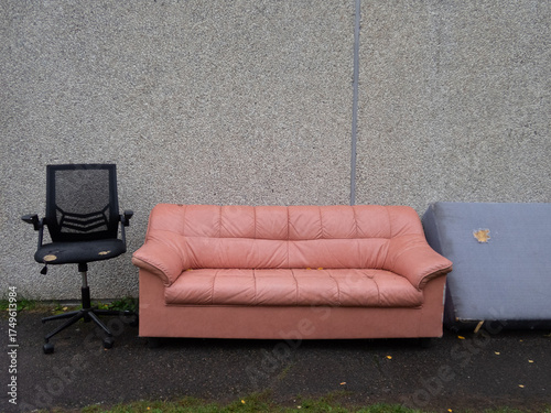 Used furniture next to the exterior wall of a second hand shop
