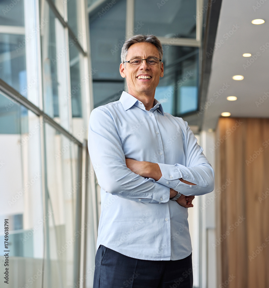 Fototapeta premium A man in a blue shirt is standing in office, businessman portrait