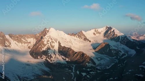 Aerial Photography of Snowy Tianshan Mountain Peaks in Xinjiang, China at Golden Hour