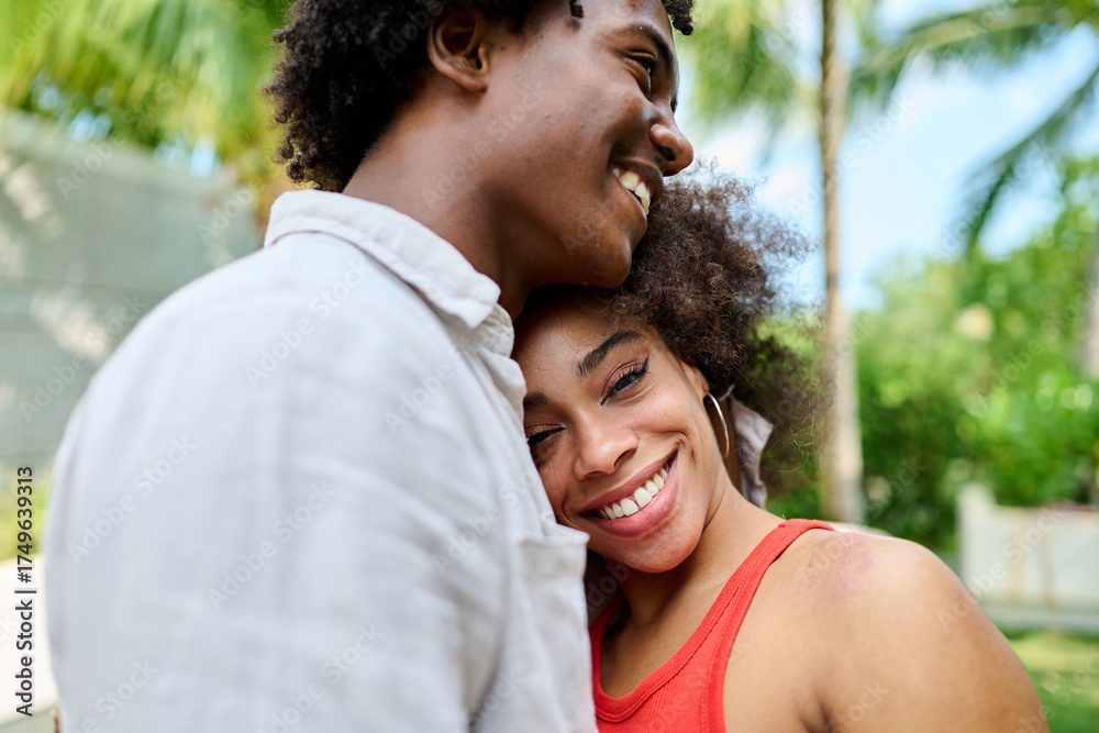 Fototapeta premium Young couple walking, bonding and enjoying a summer party by a pool, vacation love and bonding concept, luxury villa real estate