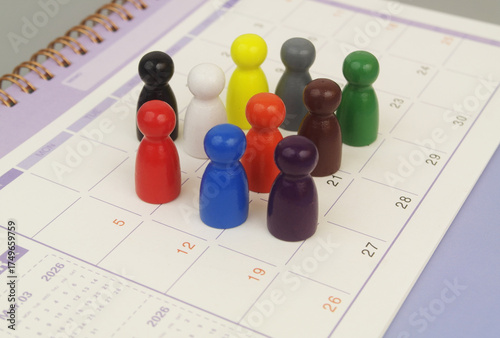 Group of different people figures on calendar page.