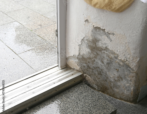 Water damage near entrance at building after heavy rainstorm c