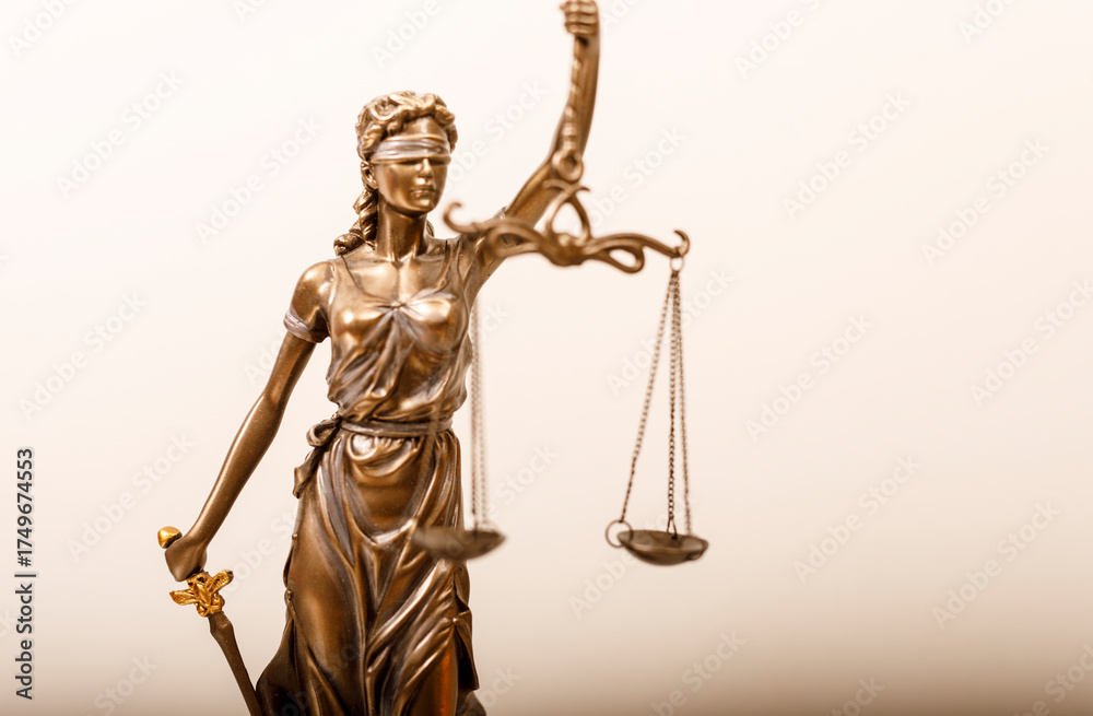 Obraz premium Lady Justice, a classical representation of justice, holding scales and sword. Depicts fairness, law, and the legal system, set against a neutra