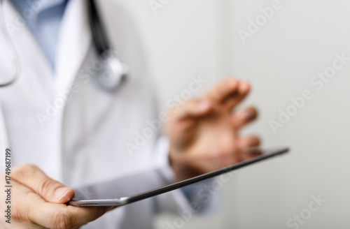 A doctor using a tablet in ...