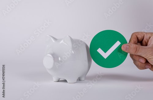 A piggy bank and checkmark ...