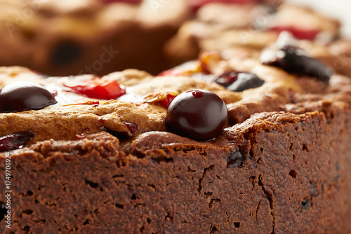 Rich chocolate cake with cherries and dark fruit, a sweet and decadent baked dessert.