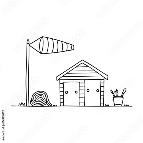 A windsock close to a maintenance shed with tools scattered nearby