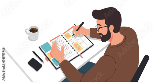 Man with beard and glasses writing in a planner on a white desk