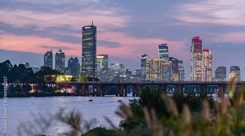 Naklejka premium Riverfront City Skyline at Dusk, Long Exposure