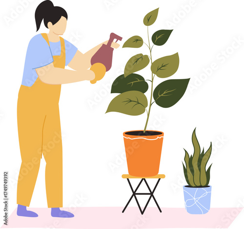 Woman watering houseplant using spray bottle for plant care