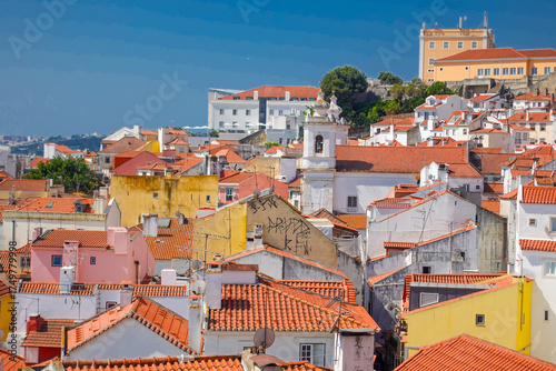 The colors of Lisbon, Portugal, in summer, sun, washed tiles, pastel facades, and the golden glow that turns every hill into a postcard