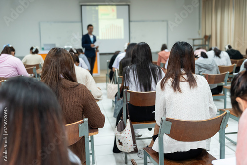 Students Taking Final Exam in Classroom Supervised by Teacher