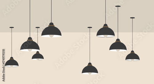 Modern black pendant lamps hanging against a beige wall  