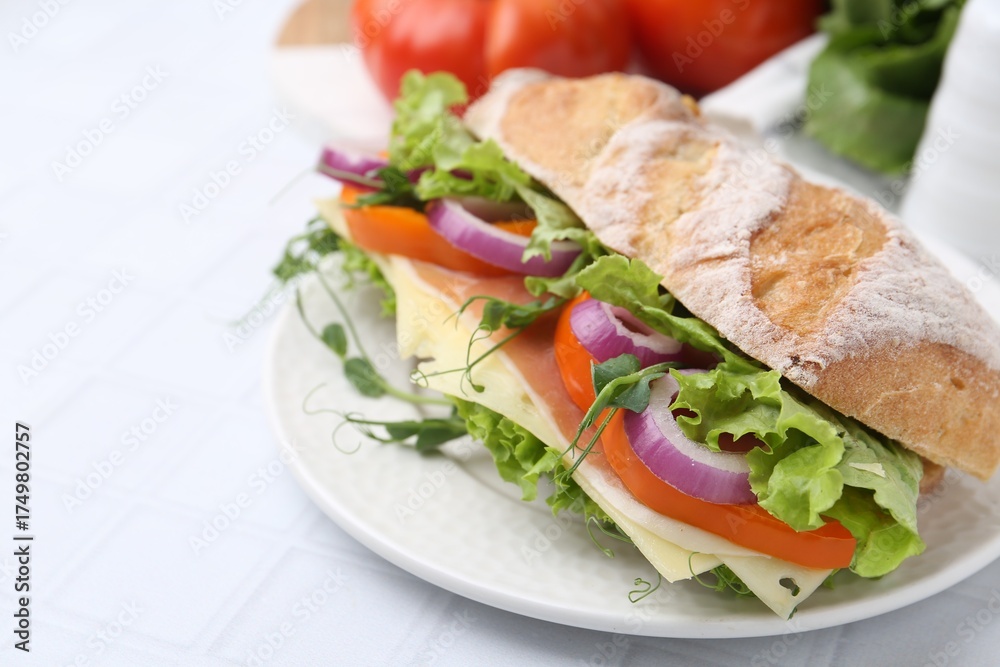 Obraz premium Delicious ciabatta sandwich with prosciutto, cheese and vegetables on white tiled table, closeup. Space for text