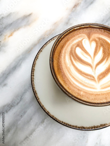 Top view coffee with latte art on marble table in cafe