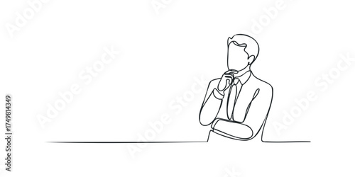 Man in suit thinking with hand on chin