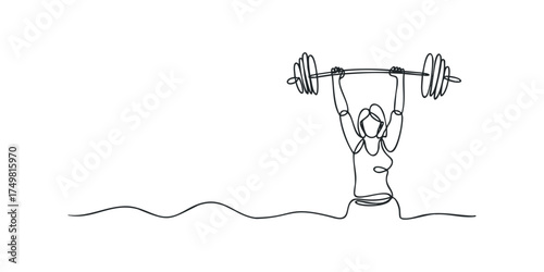 Woman lifting heavy barbell overhead in athletic pose