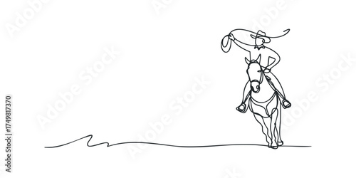 Cowboy riding horse swinging lasso