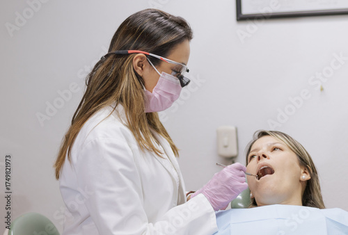 Dentist examining patient's teeth during dental checkup