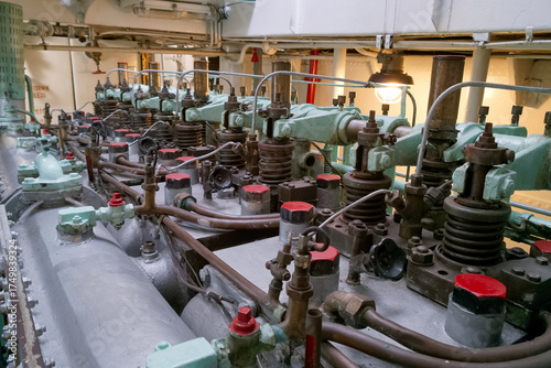 Engine room machinery details showcasing intricate components of a vintage marine engine at a historical vessel location