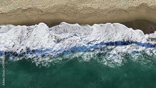 Beautiful coastal waves drone shot of Ischia island in Italy with deep blue sea waves, cliffs and sunny weather. 